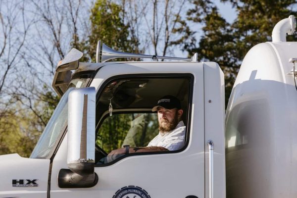 One Of Underwood Plumbing’s Skilled Technicians Pulling Up In His Truck For Emergency Septic Repairs.