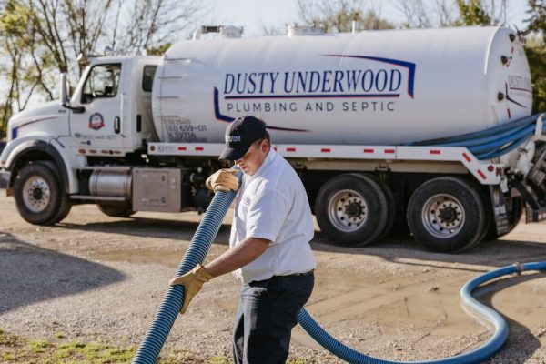 A Licensed Plumber At Underwood Plumbing And Septic Fixing A Septic Tank Backup In Texas.