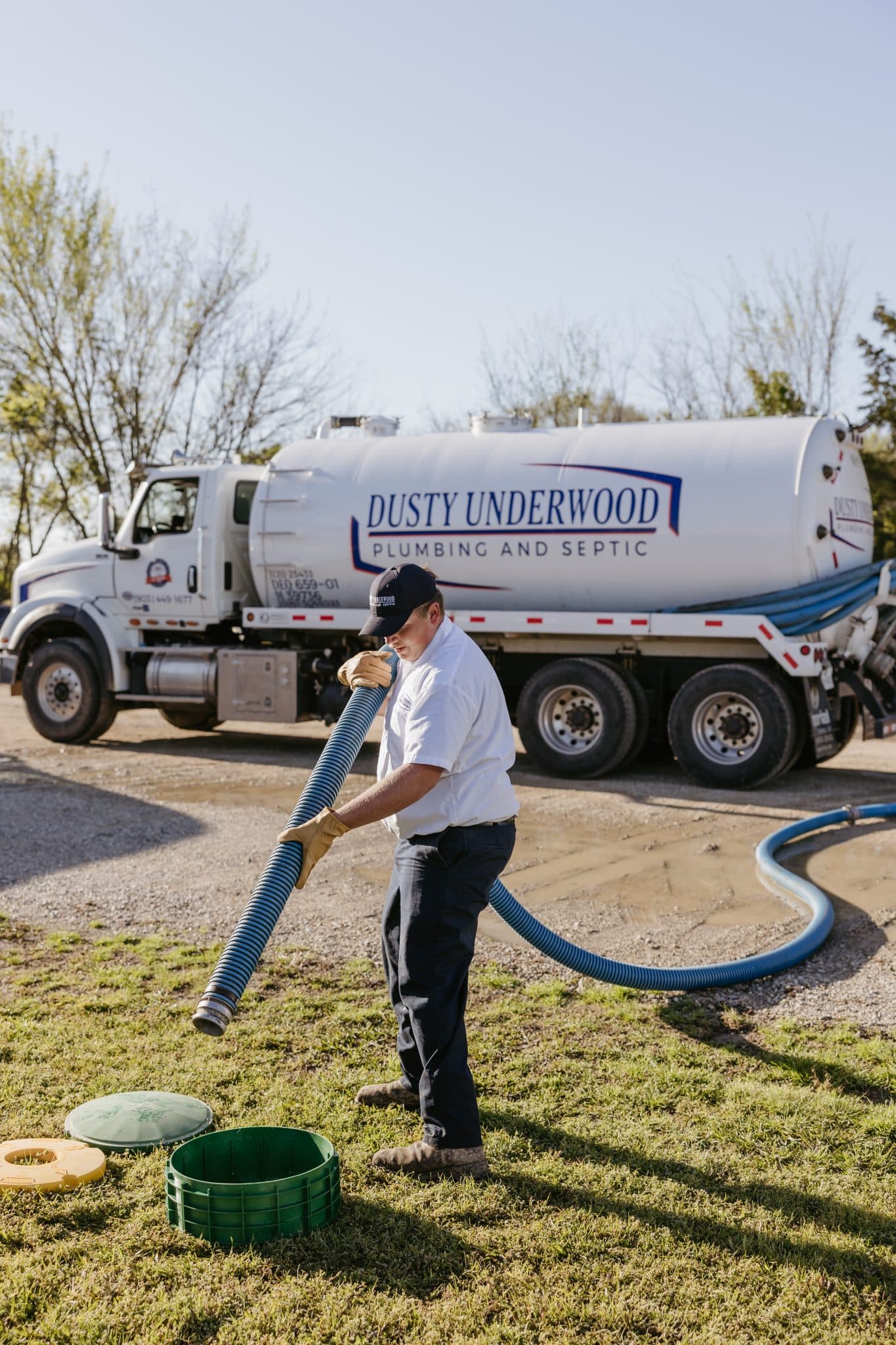 A licensed plumber at Underwood Plumbing and Septic fixing a septic tank backup in Texas.