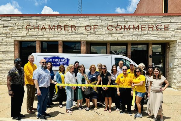 The Dusty Underwood Plumbing Team Cutting A Ribbon After Joining The Bohham Chamber Of Commerce
