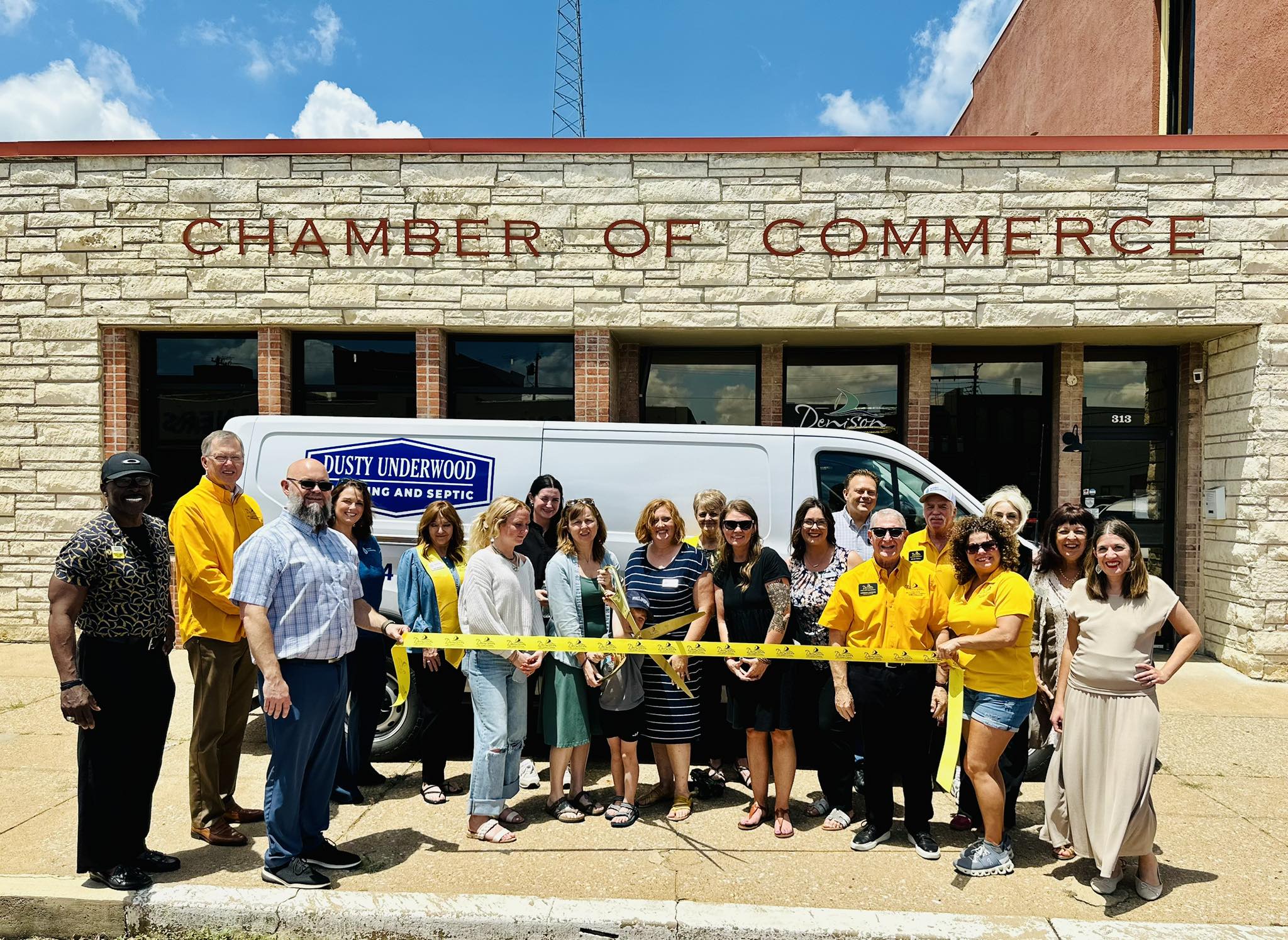 The Dusty Underwood Plumbing Team cutting a ribbon after joining the Bohham Chamber of Commerce