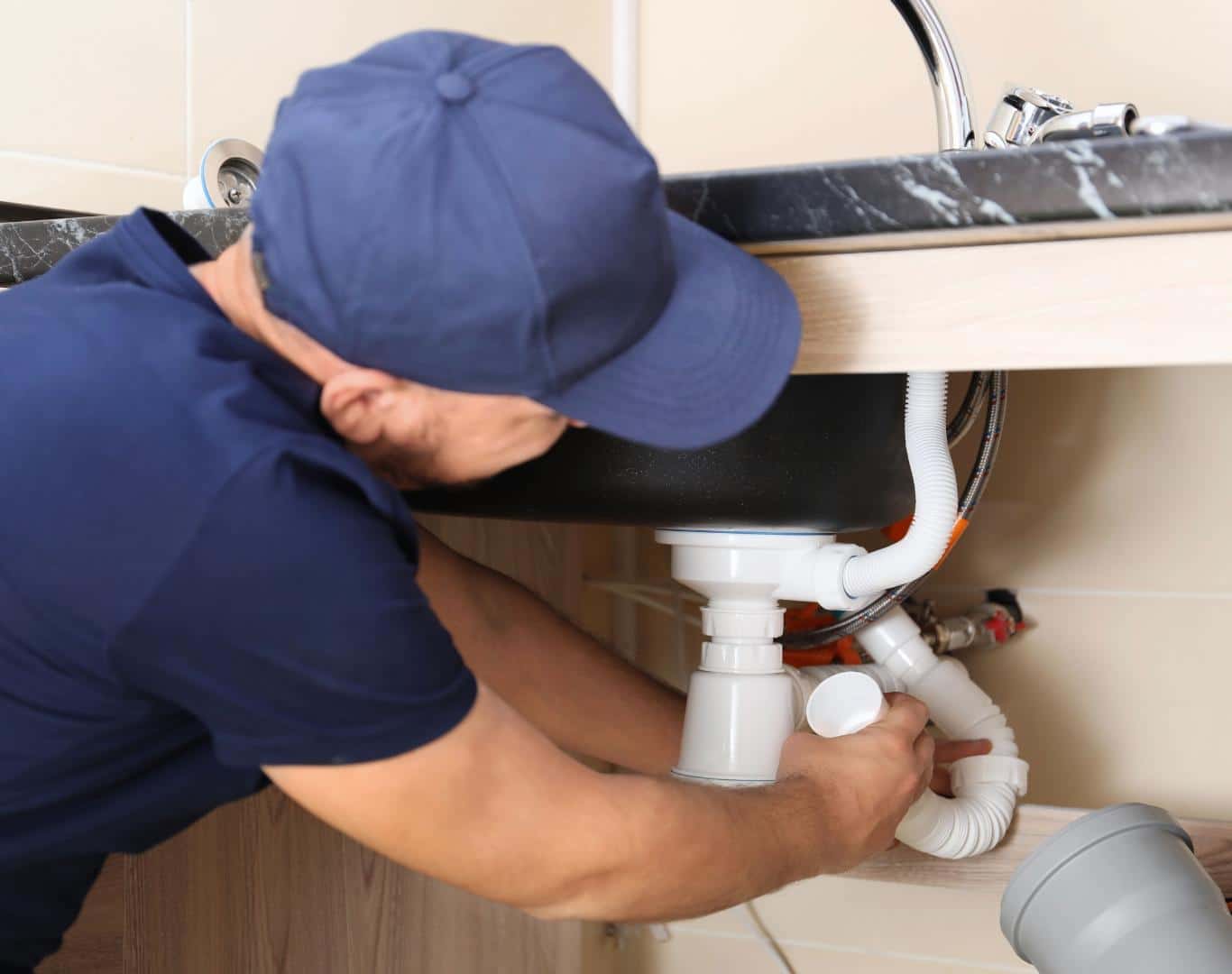 Professional plumber in Commerce, TX repairing a residential water line